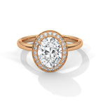 Rose gold ring with a large diamond and smaller diamonds around on a white background