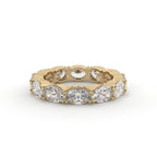 Gold ring with embedded diamonds on a white background
