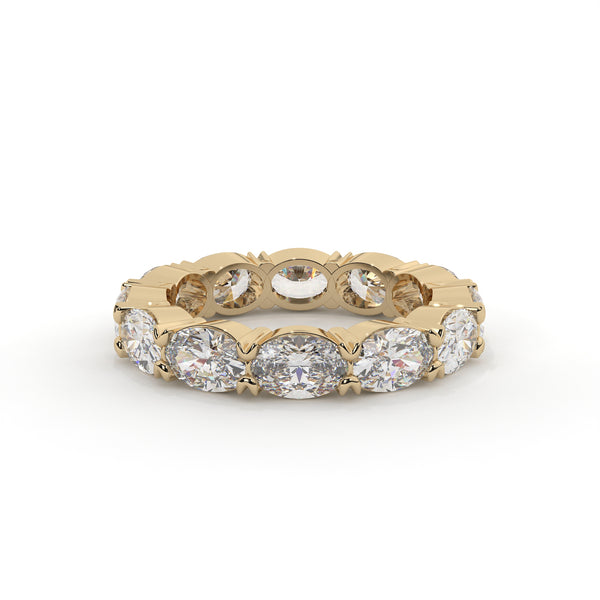 Gold ring with embedded diamonds on a white background
