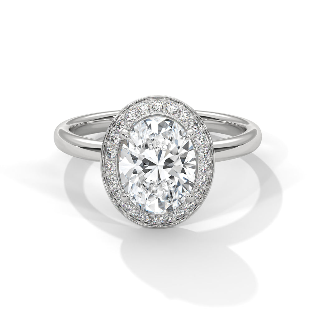 Diamond ring with a halo on a white background