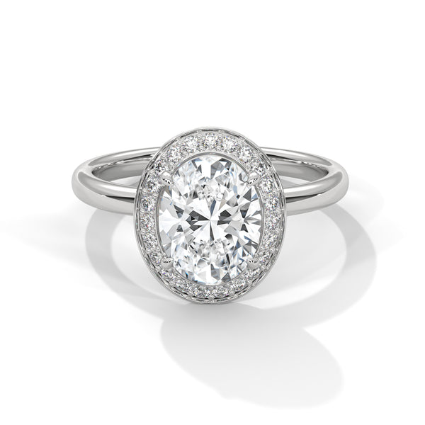 Diamond ring with a halo on a white background