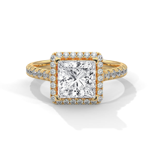 Gold ring with a large diamond and smaller diamonds on the band against a white background