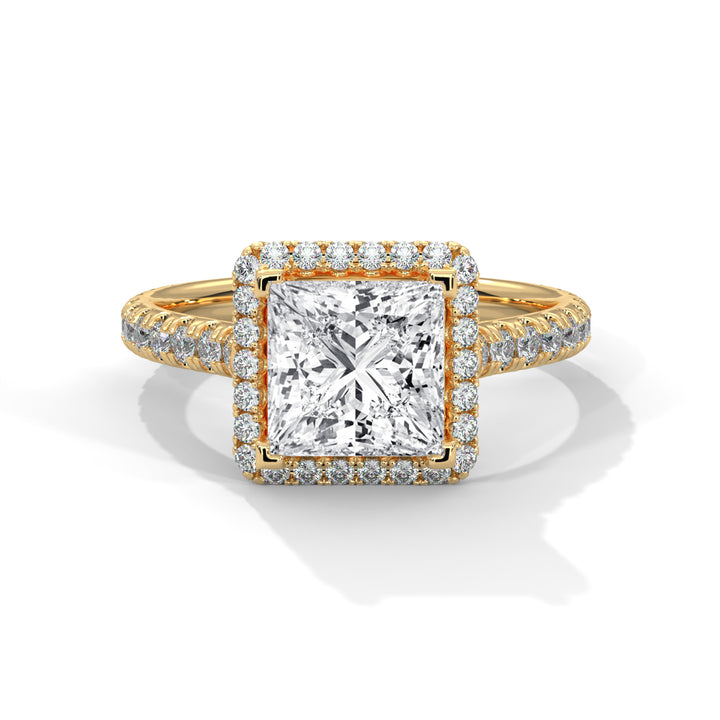 Gold ring with a large diamond and smaller diamonds on the band against a white background