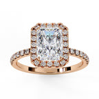 Rose gold ring with a large diamond and smaller diamonds on the band against a white background