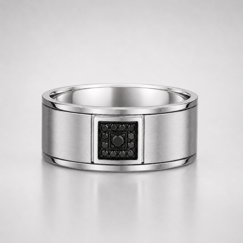 Silver ring with a black gemstone on a light gray background