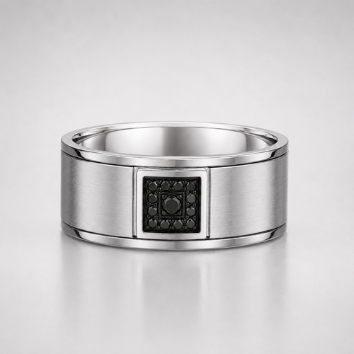 Silver ring with a black gemstone on a light gray background