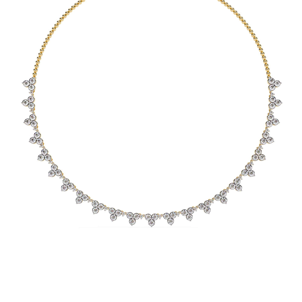 Gold necklace with diamond-like stones on a white background