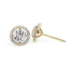 Gold diamond stud earrings on a white background