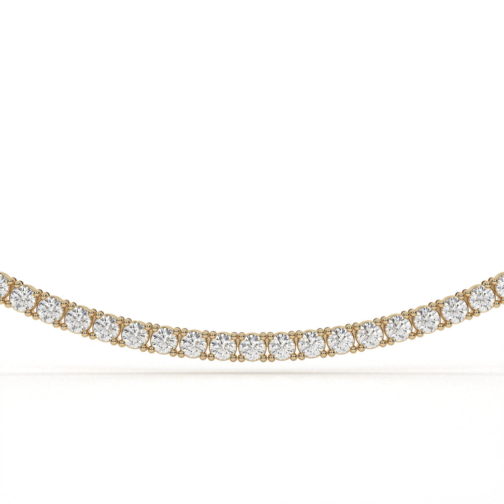 Gold necklace with clear gemstones on a white background