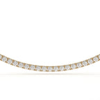 Gold necklace with clear gemstones on a white background