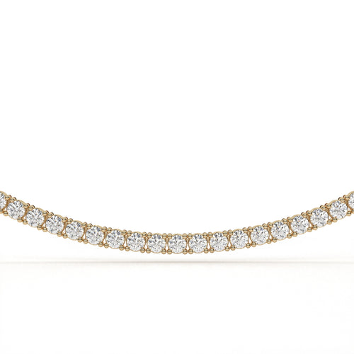 Gold necklace with clear gemstones on a white background