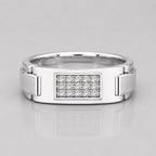 Silver ring with diamond-studded center on a light gray background