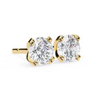 Gold stud earrings with clear gemstones on a white background