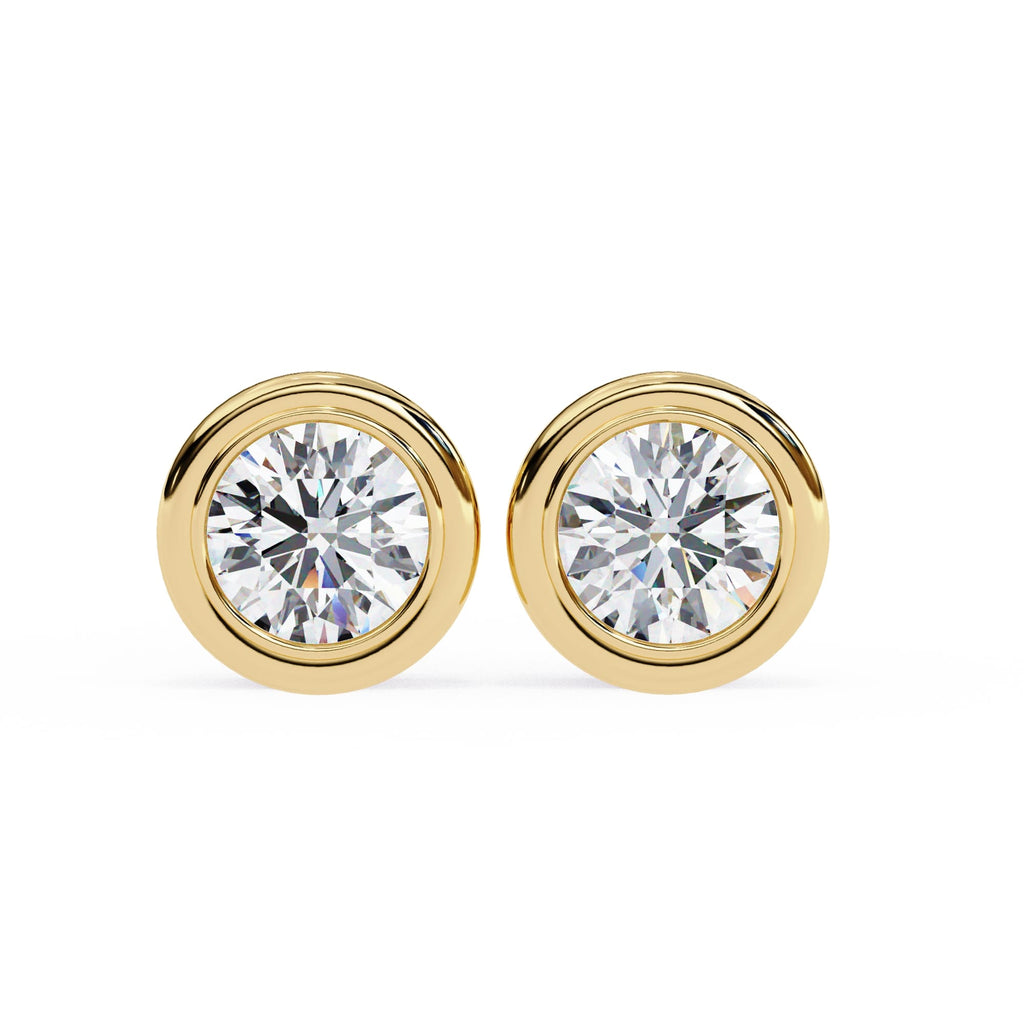 Gold stud earrings with clear gemstones on a white background