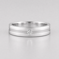 Silver ring with a diamond on a light gray background