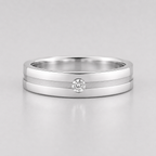 Silver ring with a diamond on a light gray background