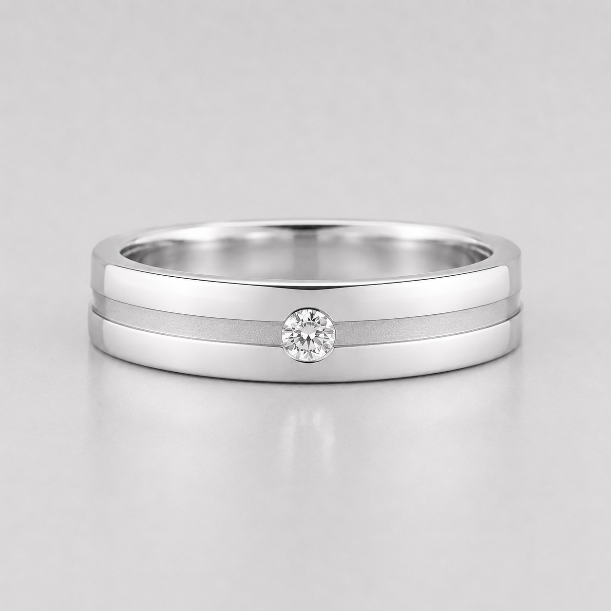 Silver ring with a diamond on a light gray background