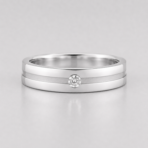 Silver ring with a diamond on a light gray background
