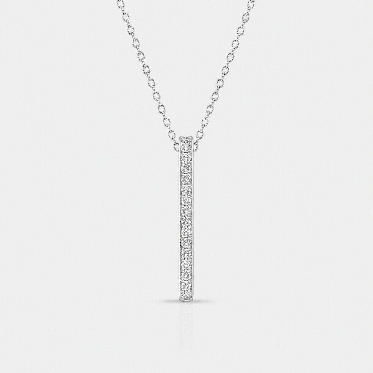 Silver necklace with a bar pendant on a light gray background
