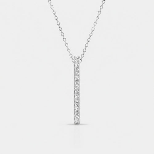 Silver necklace with a bar pendant on a light gray background