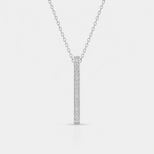 Silver necklace with a bar pendant on a light gray background