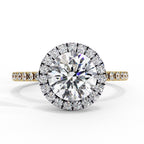 Diamond ring with a large central gemstone and smaller stones on a white background
