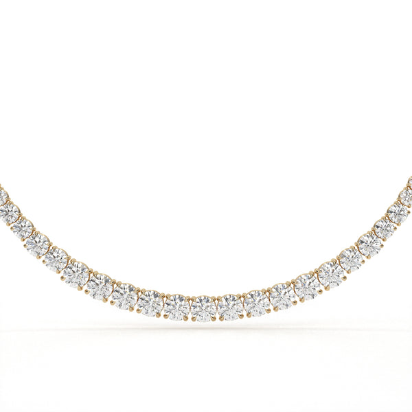 Gold necklace with clear gemstones on a white background