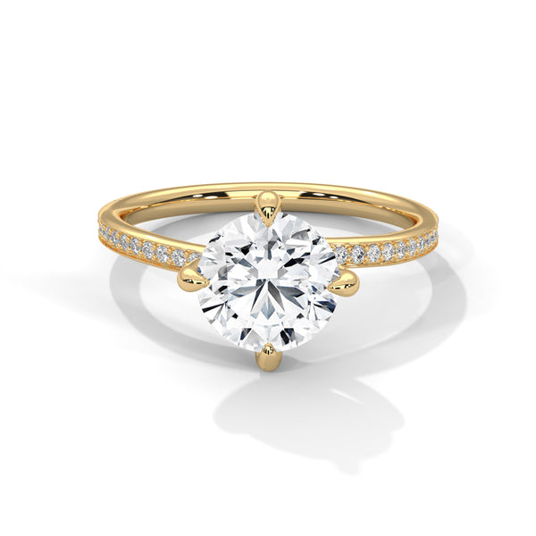 Gold ring with a large diamond and smaller diamonds on the band against a white background