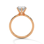 Rose gold ring with a diamond on a white background