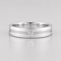 Round lab grown diamond flush set engagement ring for men featuring a satin center groove with a single flush set round diamond in a polished white gold band.