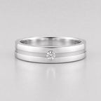 Round lab grown diamond flush set engagement ring for men featuring a satin center groove with a single flush set round diamond in a polished white gold band.