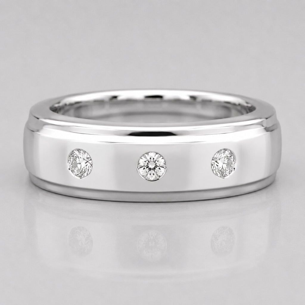 Silver ring with three diamonds on a light gray background