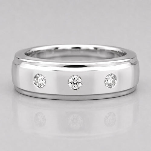 Silver ring with three diamonds on a light gray background