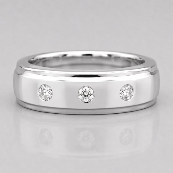 Silver ring with three diamonds on a light gray background