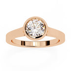 Rose gold ring with a diamond on a white background