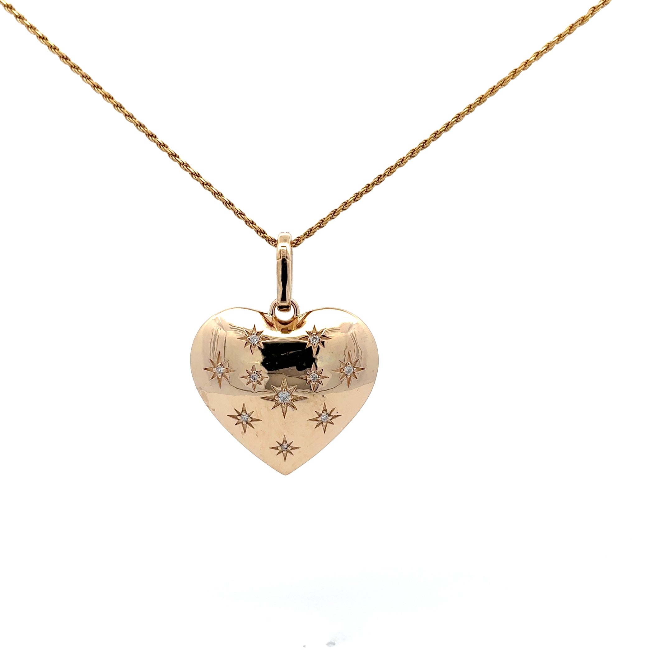 Gold heart-shaped pendant necklace with engraved details on a white background