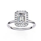 Diamond ring with emerald-cut center stone on a white background