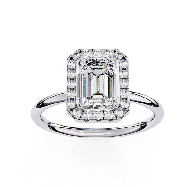 Diamond ring with emerald-cut center stone on a white background