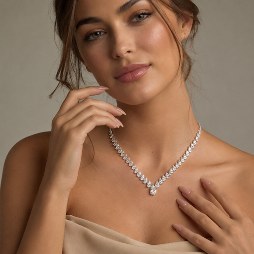 Woman wearing a diamond necklace against a neutral background