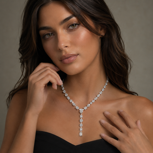 Woman wearing a diamond necklace against a neutral background