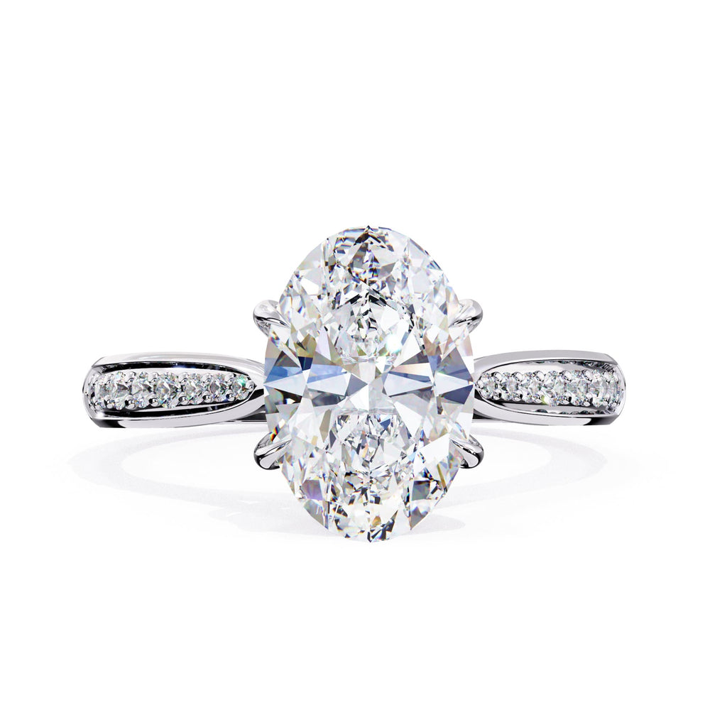 Diamond ring with two large oval diamonds and smaller diamonds on the band against a white background