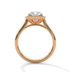 Side profile of a cushion cut diamond halo engagement ring in rose gold with an open gallery setting and plain band.
