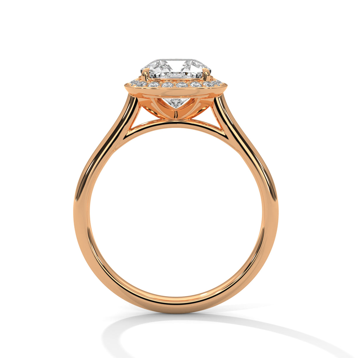 Side profile of a cushion cut diamond halo engagement ring in rose gold with an open gallery setting and plain band.
