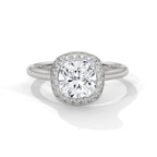 Cushion cut diamond halo engagement ring in white gold with a plain band, shown in a front product view.