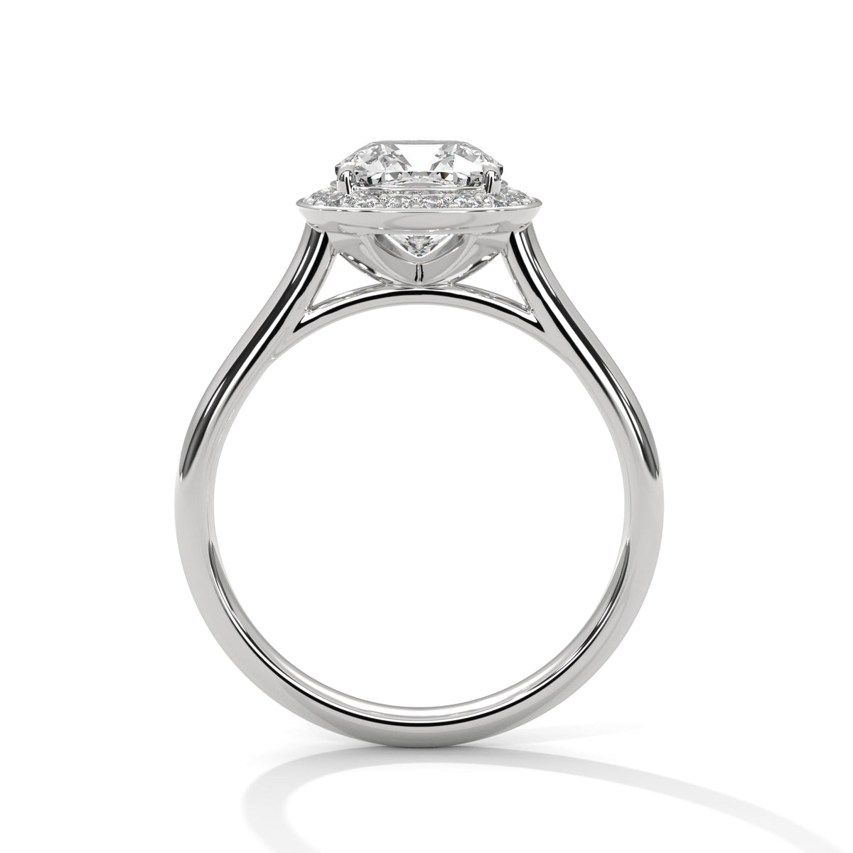 Side profile of a cushion cut diamond halo engagement ring in white gold with an open gallery setting and plain band.