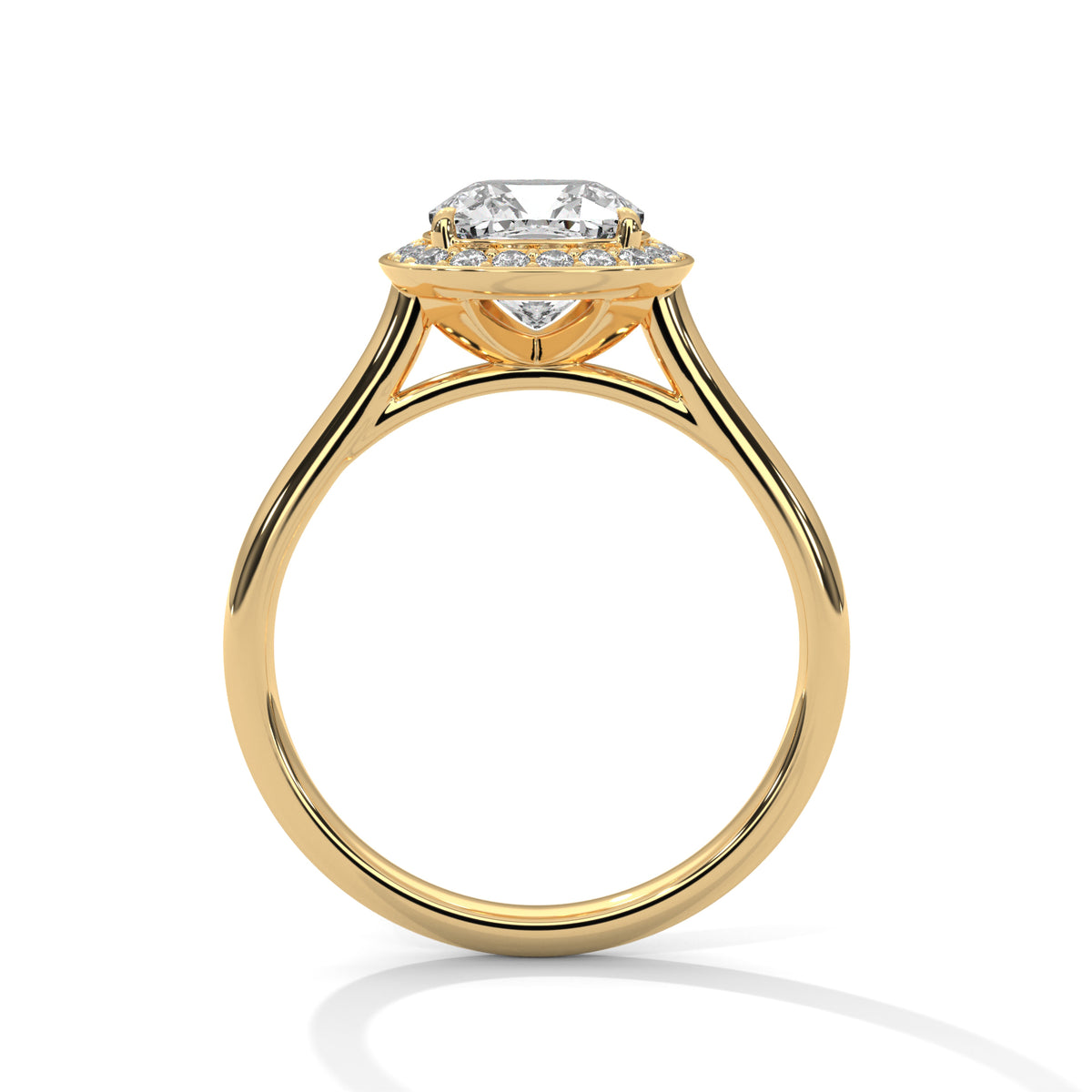 Side profile of a cushion cut diamond halo engagement ring in yellow gold with an open gallery setting and plain band.
