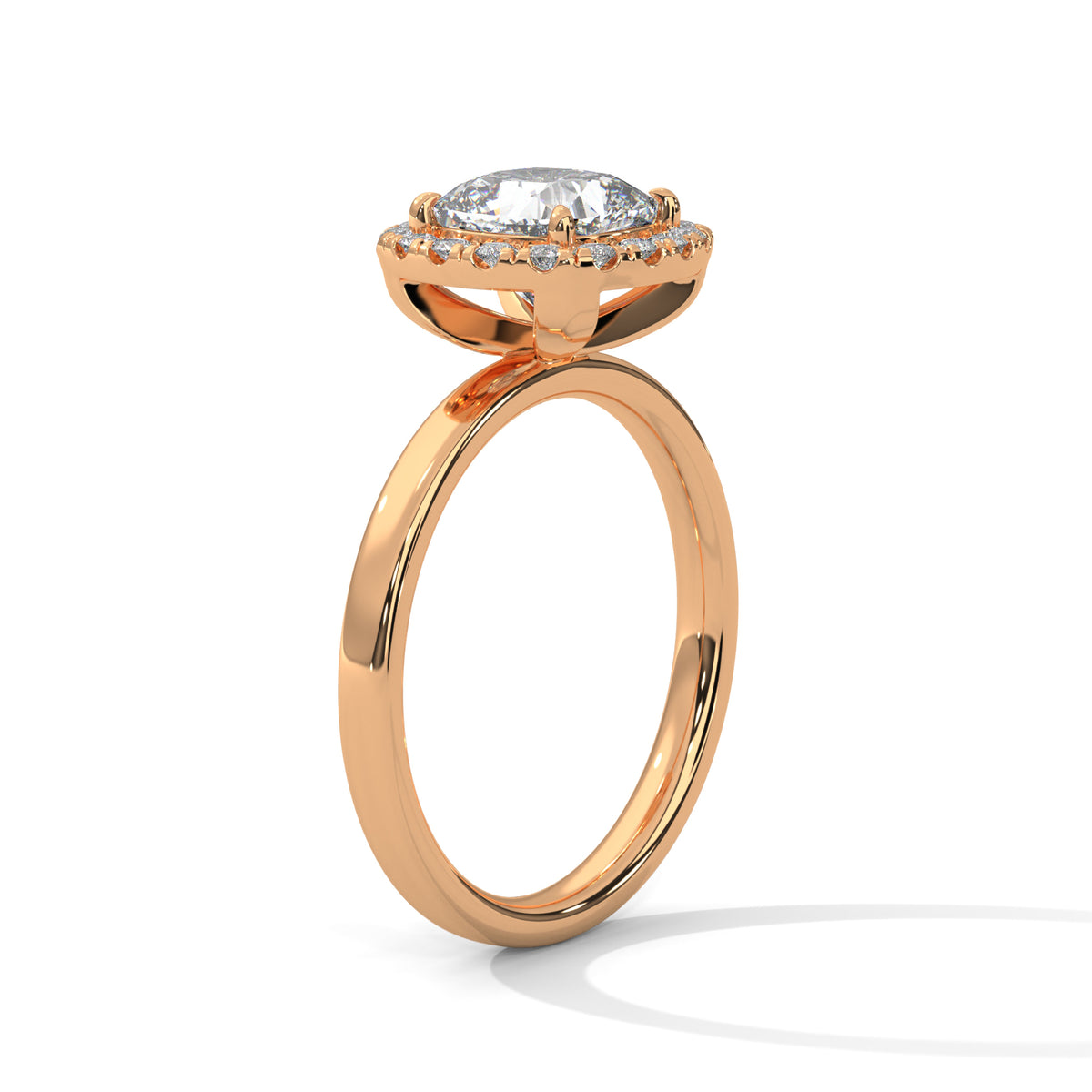 Angled side view of a cushion cut diamond halo engagement ring in rose gold with a plain band and raised halo setting.