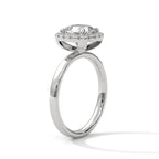 Angled side view of a cushion cut diamond halo engagement ring in white gold with a plain band and raised halo setting.