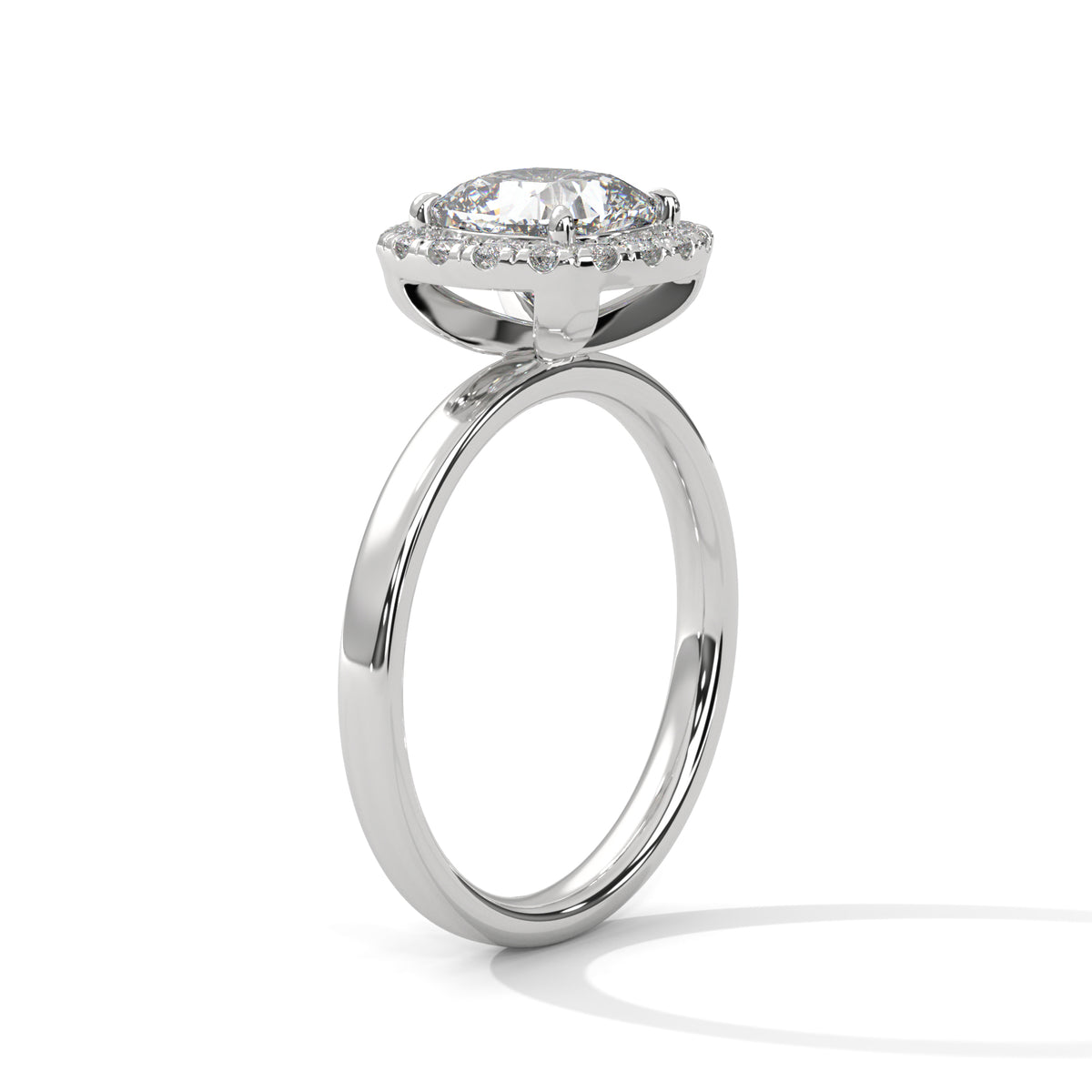 Angled side view of a cushion cut diamond halo engagement ring in white gold with a plain band and raised halo setting.