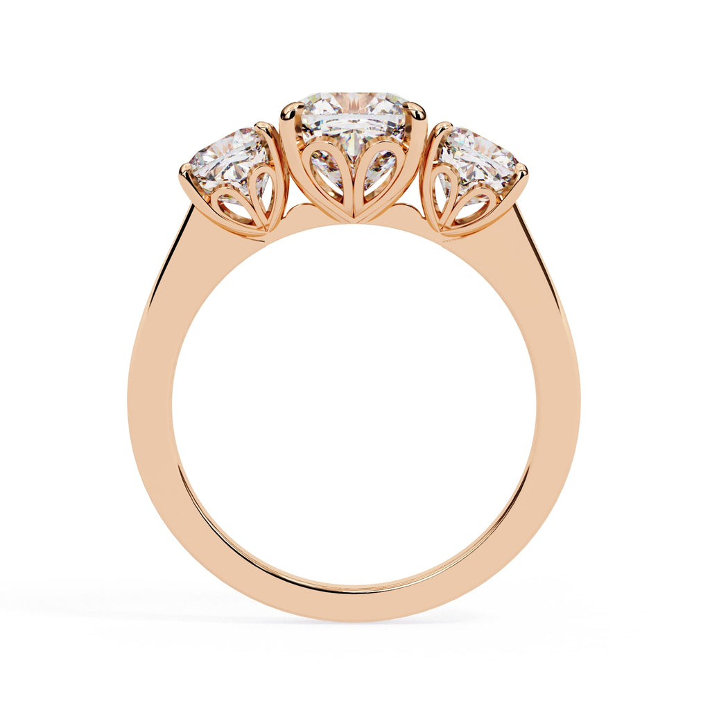 Rose gold ring with three diamonds on a white background